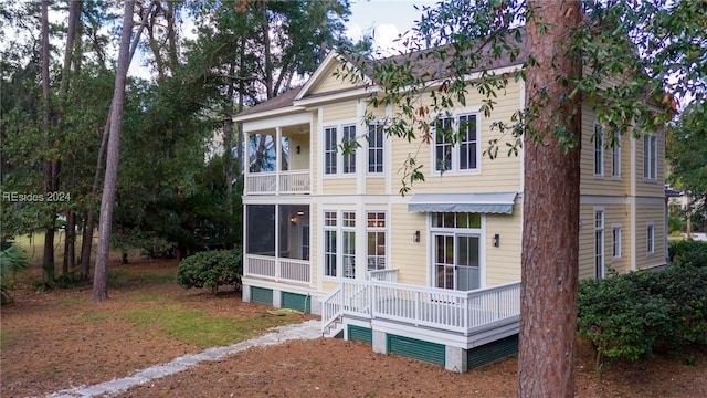 rear view of property with a sunroom