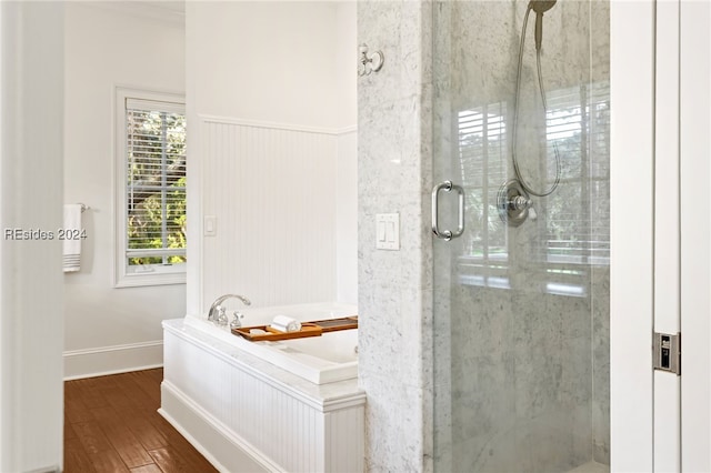 bathroom with wood-type flooring and separate shower and tub