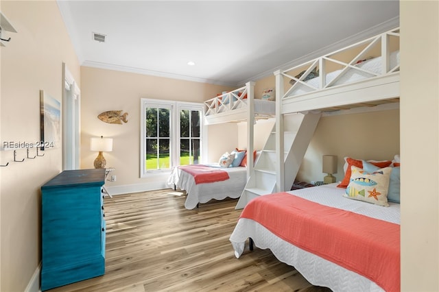 bedroom featuring hardwood / wood-style flooring and ornamental molding