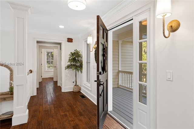 interior space with decorative columns, crown molding, and dark hardwood / wood-style flooring