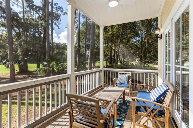 sunroom / solarium featuring lofted ceiling, a wealth of natural light, and ceiling fan