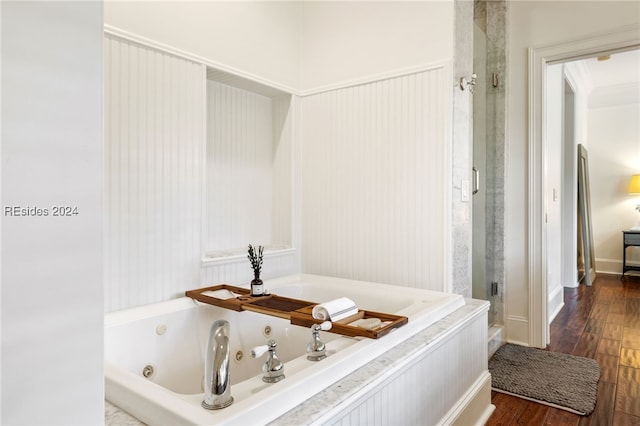 bathroom featuring hardwood / wood-style flooring, ornamental molding, and separate shower and tub