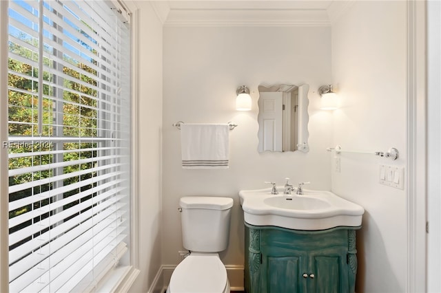 bathroom with crown molding, vanity, and toilet