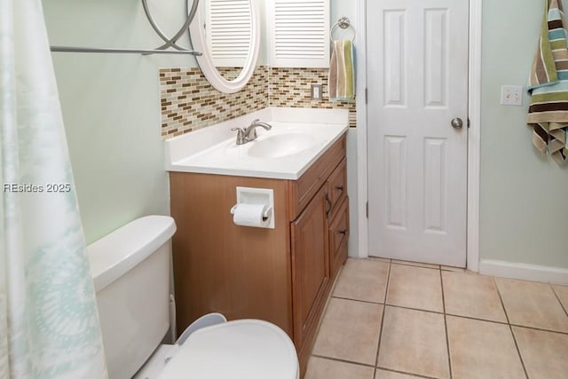 bathroom with vanity, toilet, tile patterned flooring, and decorative backsplash