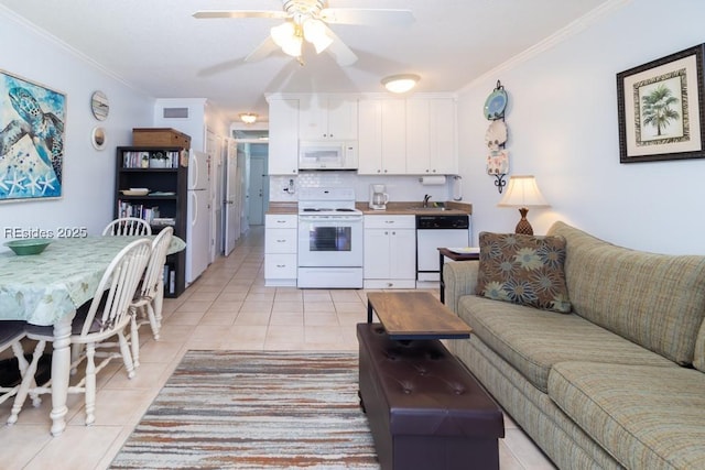 kitchen featuring white cabinetry, ornamental molding, light tile patterned floors, ceiling fan, and white appliances