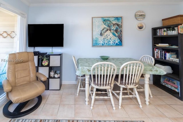 dining space with light tile patterned floors and crown molding