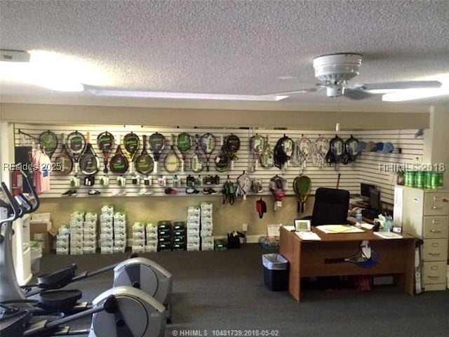 gym featuring ceiling fan and a textured ceiling