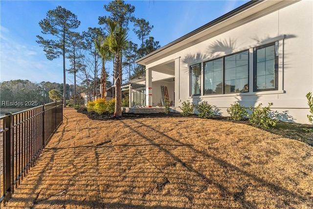 view of side of property with a yard