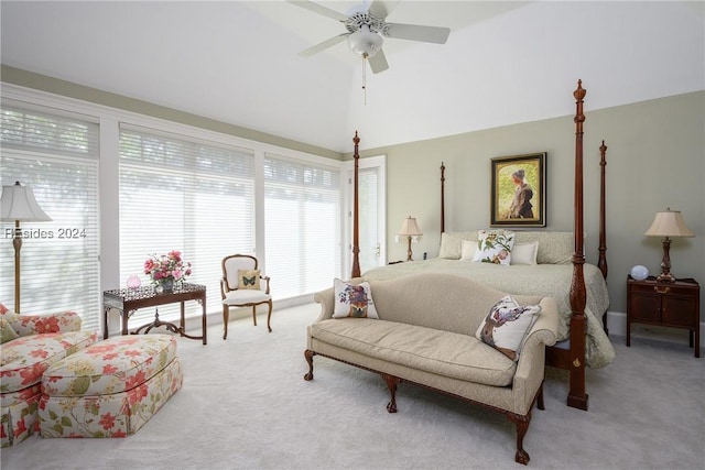 carpeted bedroom featuring ceiling fan and a high ceiling