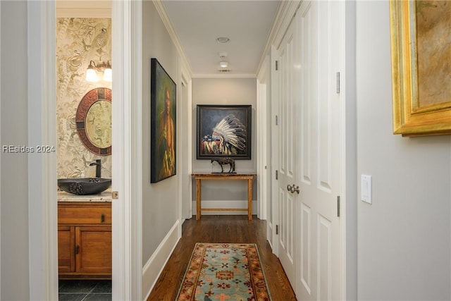 hallway featuring ornamental molding, sink, and dark hardwood / wood-style flooring