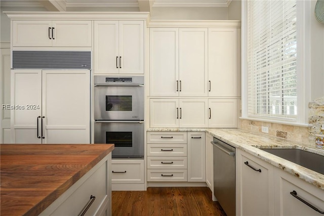 kitchen featuring white cabinets, wooden counters, dark hardwood / wood-style flooring, stainless steel appliances, and crown molding