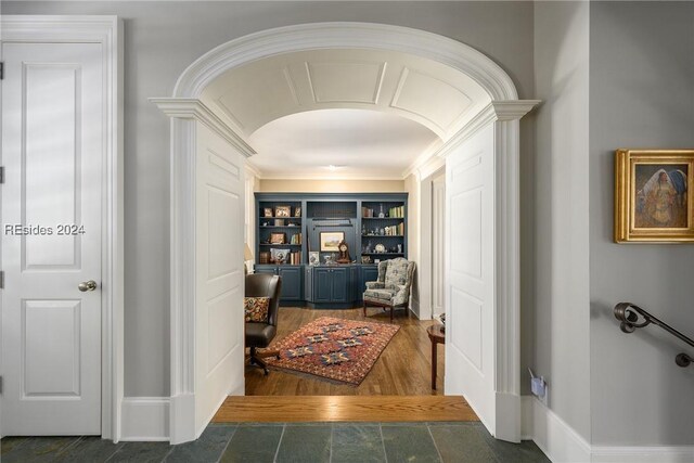 hall with crown molding and built in shelves