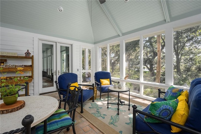 sunroom with lofted ceiling with beams and french doors