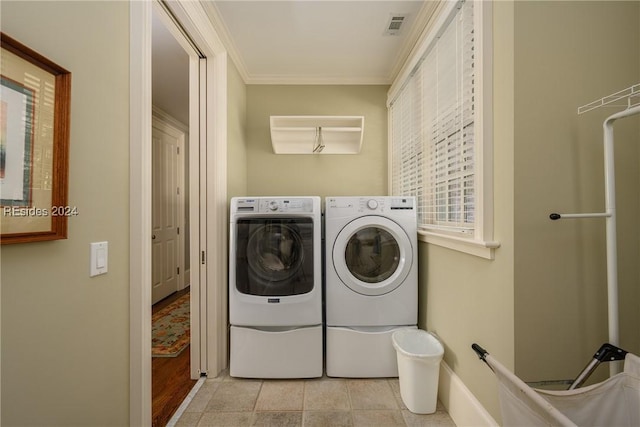 laundry area with crown molding and washer and dryer