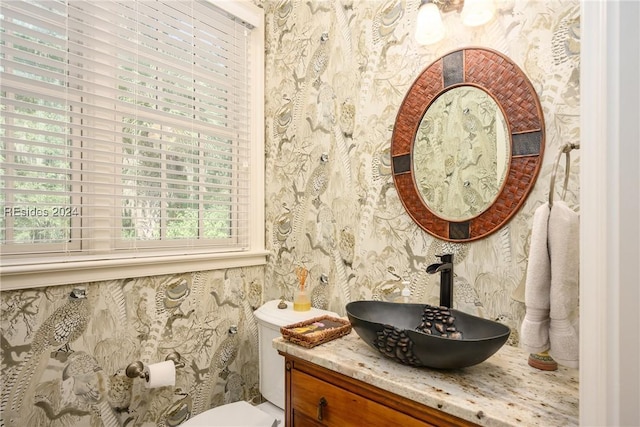 bathroom featuring vanity and toilet