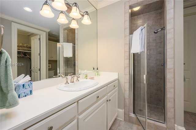 bathroom with tile patterned floors, ornamental molding, an enclosed shower, and vanity