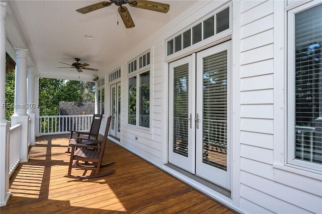 wooden terrace with a porch, ceiling fan, and french doors