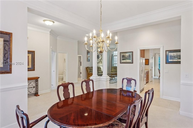 dining area with ornamental molding and a chandelier