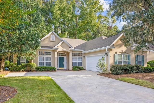 single story home featuring a garage and a front lawn