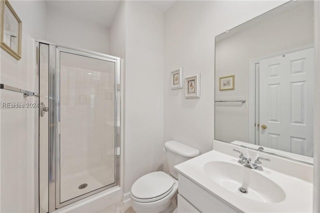 bathroom featuring an enclosed shower, vanity, and toilet