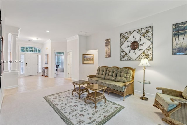 carpeted living room featuring decorative columns and ornamental molding