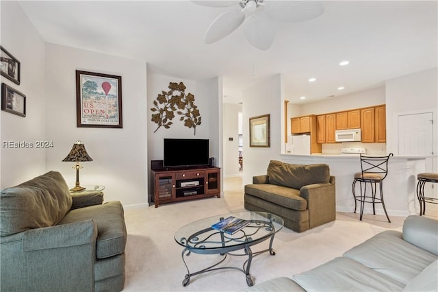 carpeted living room with ceiling fan