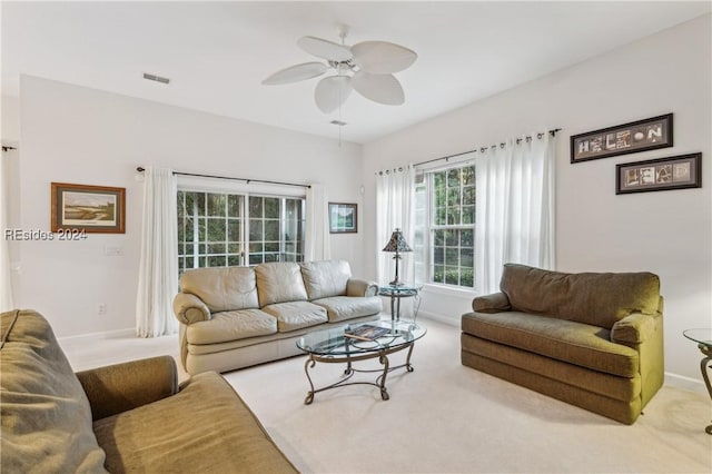 carpeted living room featuring ceiling fan