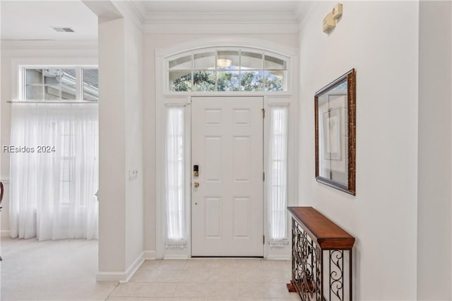 entryway featuring ornamental molding and light carpet