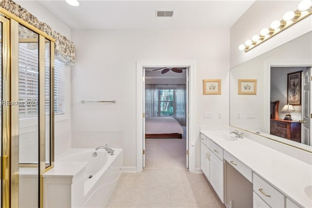 bathroom featuring vanity, a bathing tub, and tile patterned floors