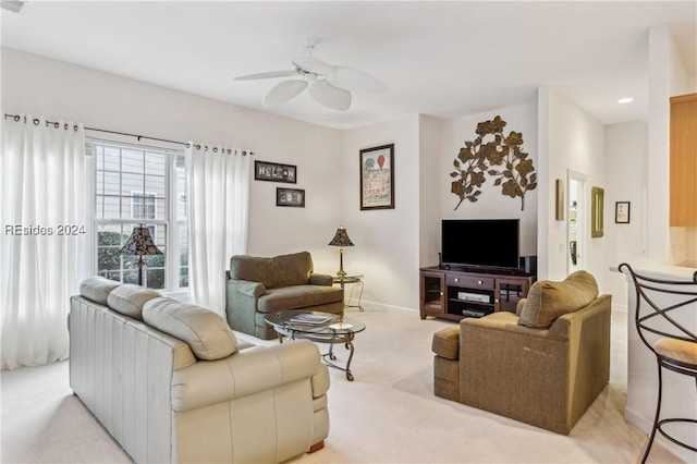 carpeted living room with ceiling fan