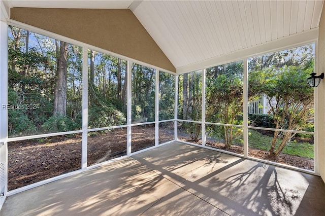 unfurnished sunroom featuring lofted ceiling