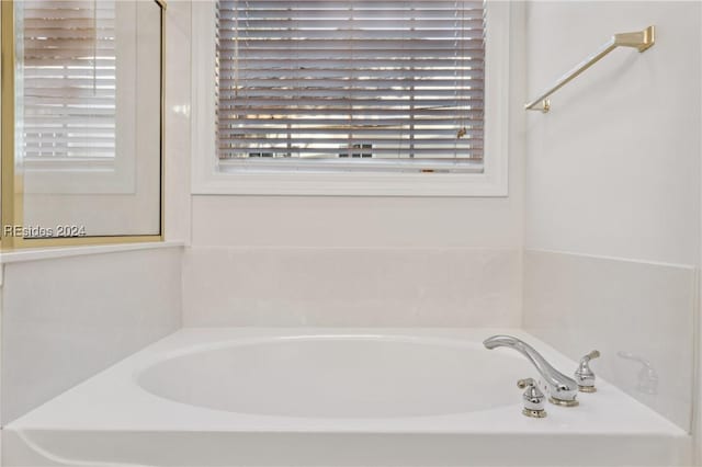 bathroom featuring a tub to relax in