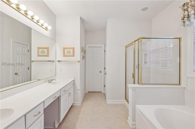 bathroom featuring tile patterned floors, vanity, and shower with separate bathtub