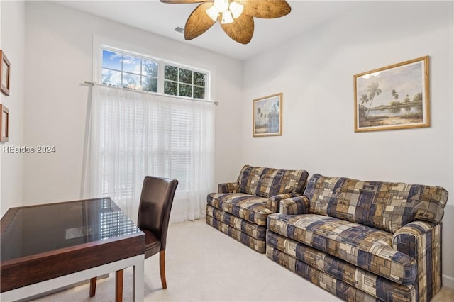 carpeted office space featuring ceiling fan