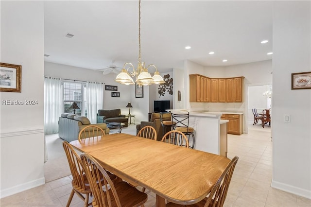 tiled dining space featuring a notable chandelier