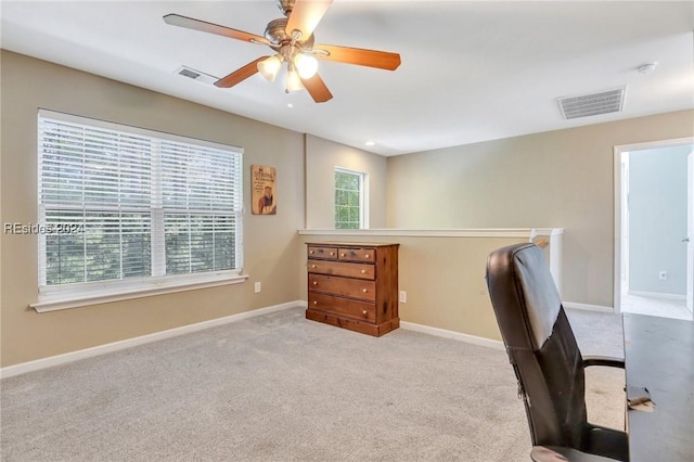 carpeted office featuring ceiling fan