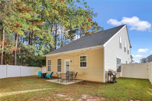 rear view of house with a yard and a patio area