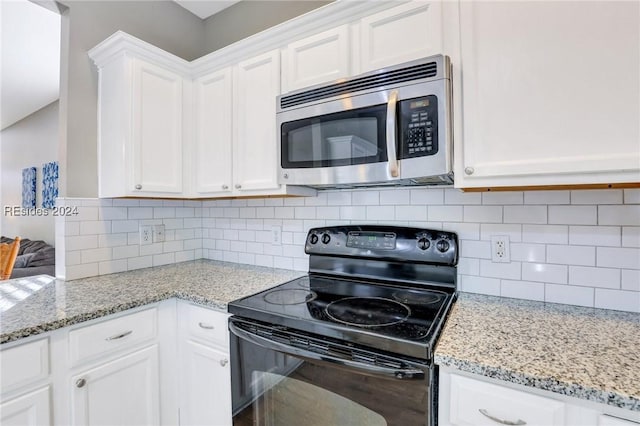 kitchen with white cabinetry, black range with electric stovetop, and decorative backsplash