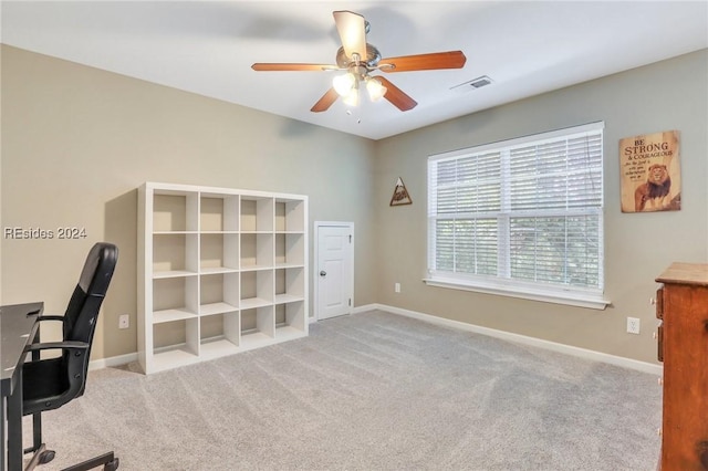 carpeted office space with ceiling fan