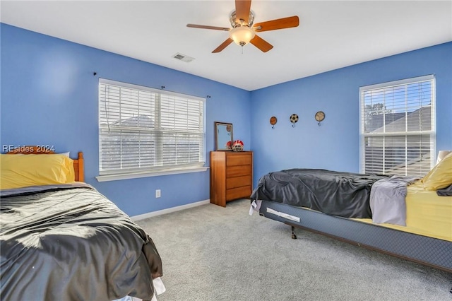 bedroom with ceiling fan and light colored carpet