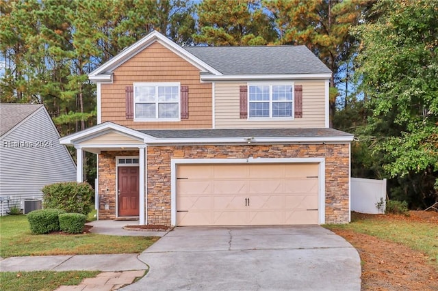 view of front of house with a garage and central AC