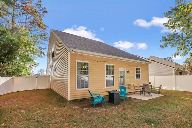 back of property featuring a yard and a patio area