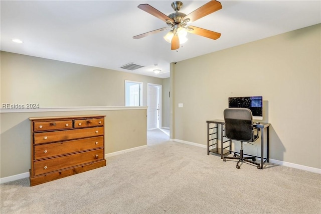 carpeted home office featuring ceiling fan