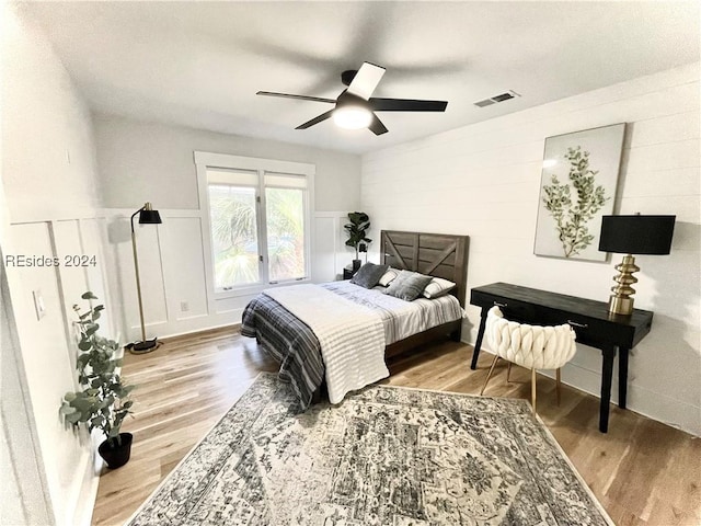 bedroom with ceiling fan and hardwood / wood-style floors