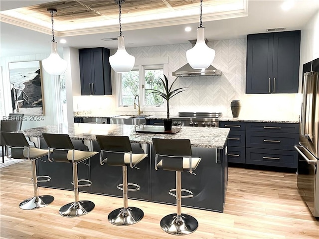 kitchen with light stone countertops, a center island, and a breakfast bar area