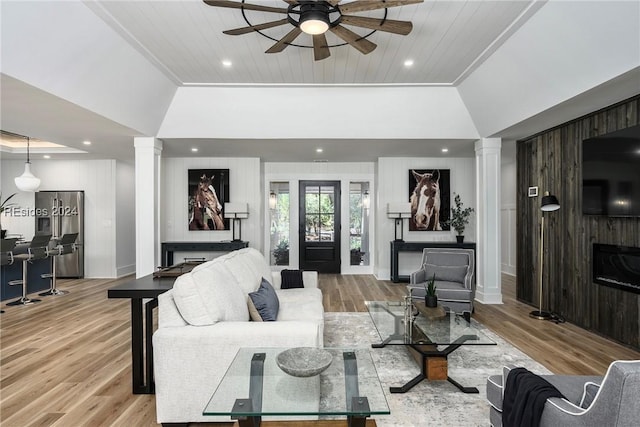 living room with decorative columns, lofted ceiling, light wood-type flooring, and wood ceiling