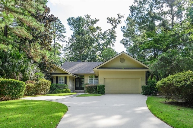 ranch-style house featuring a garage and a front yard