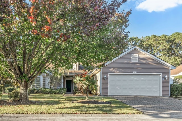 view of front of property featuring a garage and a front lawn