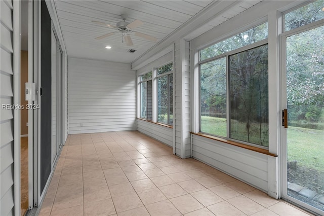 unfurnished sunroom with wooden ceiling and ceiling fan