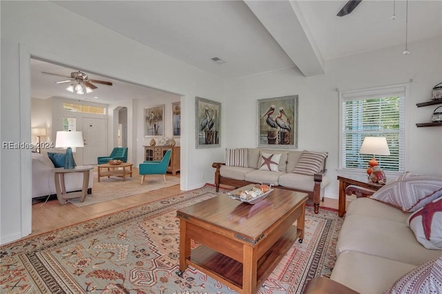 living room with beam ceiling and ceiling fan